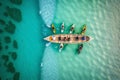 Aerial drone top down photo of sport canoe operated by team of young men in emerald calm sea waters Royalty Free Stock Photo