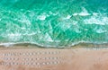 Aerial drone top down shot of empty beach and clean blue sea. Beautiful beach with empty sunbeds Royalty Free Stock Photo