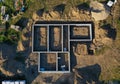 Aerial drone top down view on construction site with reinforced concrete house foundation, brick wall and materials like wall Royalty Free Stock Photo