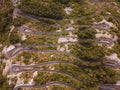 Aerial drone top down view of serpentine road in Kotor bay, Montenegro. Vehicles drive on winding mountain road leading Royalty Free Stock Photo