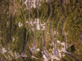 Aerial drone top down view of serpentine road in Kotor bay, Montenegro. Vehicles drive on winding mountain road leading Royalty Free Stock Photo