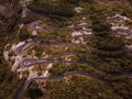 Aerial drone top down view of serpentine road in Kotor bay, Montenegro. Vehicles drive on winding mountain road leading Royalty Free Stock Photo