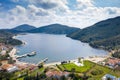 Aerial drone top view of fairytale hills valley with a round blue lake, country houses with a red roof tiles, summer green gardens Royalty Free Stock Photo