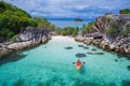 Aerial top view of man kayaking in crystal clear lagoon sea water near Koh Kra island in Thailand Royalty Free Stock Photo