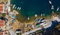 Aerial drone top view photo of colourful wooden traditional fishing boat in turquoise sea shore of Simy island, Greece