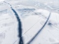 Aerial drone top view of snow covered frozen lake or river surface with big cracked ice diagonal lines. Natural winter Royalty Free Stock Photo