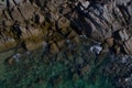 Aerial top view of turquoise sea surface with stones and rocks in water Royalty Free Stock Photo