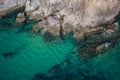 Aerial top view of turquoise sea surface with stones and rocks in water Royalty Free Stock Photo