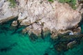 Aerial top view of turquoise sea surface with stones and rocks in water Royalty Free Stock Photo