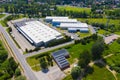 Aerial drone on trucks and logistic center. Warehouse aerial. Modern logistics center, white van and trailers standingon ramp