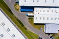 Aerial drone on trucks and logistic center. Warehouse aerial. Modern logistics center, white van and trailers standingon ramp