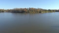 Aerial drone video panning very slowly from right to left over the calm water of the river in Rosemere with an island as point of