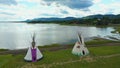 Aerial drone video, rotating from left to right, near tipis facing a bay at Maria in Gaspesie, Quebec