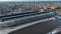 Aerial drone view Amsterdam Central Train Station with Amsterdam sign on roof. Bird's eye view autumn cityscape Royalty Free Stock Photo