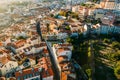 Aerial drone view of apeople at two viewpoints overlooking Lisbon, Portugal at sunset