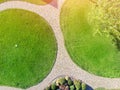 Aerial drone view of backyard garden with circle wath path, green grass lawn and trees. Landscape design and gardening Royalty Free Stock Photo