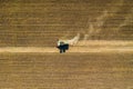 Aerial drone view with beautiful autumn landscape of working tractor on the harvest field. Agriculture concept. Royalty Free Stock Photo