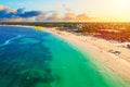 Aerial drone view of beautiful caribbean tropical beach with palms and parasailing balloon during sunset. Bavaro, Punta Cana,