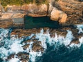 Aerial drone view of Blue Pool in Bermagui during sunrise sunset with blue sky and reflection. New South Wales