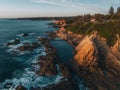 Aerial drone view of Blue Pool in Bermagui during sunrise sunset with blue sky and reflection. New South Wales