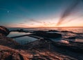 Aerial drone view of Blue Pool in Bermagui during sunrise sunset with blue sky and reflection. New South Wales