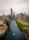 Aerial drone view of a boat sailing on the Chicago river under a bridge Royalty Free Stock Photo