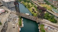 Aerial drone view of a boat sailing on the Chicago river under a bridge Royalty Free Stock Photo