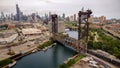 Aerial drone view of a boat sailing on the Chicago river under a bridge Royalty Free Stock Photo