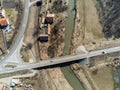 Aerial drone view, bridge over dirty Olt river , passing cars, small hungarian village in Transylvania Royalty Free Stock Photo