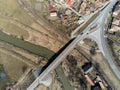 Aerial drone view, bridge over dirty Olt river , passing cars, small hungarian village in Transylvania Royalty Free Stock Photo