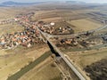 Aerial drone view, bridge over dirty Olt river , passing cars, small hungarian village in Transylvania Royalty Free Stock Photo