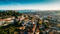Aerial drone view of Castelo Sao Jorge on foreground with Lisbon, Portugal baixa district in background including 25 April Bridge Royalty Free Stock Photo