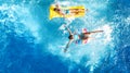 Aerial drone view of children in swimming pool from above, happy kids swim on inflatable ring donuts, girls have fun in water Royalty Free Stock Photo