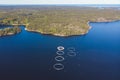 Aerial drone view of circle sea fish farm cages and round fishing nets, farming salmon, trout and cod, feeding the fish a forage, Royalty Free Stock Photo