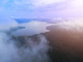 Aerial Drone view clouds over the green forest and lake. Low lying cloud. Aerial view of over tropical rainforest. Above the cloud Royalty Free Stock Photo