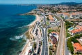 Aerial drone view of coastline hugging the Marginal Avenue with Sao Pedro de Estoril district in Greater Lisbon, Portugal Royalty Free Stock Photo