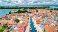 Aerial view of colorful Burano island in Venetian lagoon sea from above, Italy