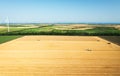 Aerial drone view: combine harvesters working in wheat field on sunset. Harvesting machine driver cutting crop in farmland Royalty Free Stock Photo
