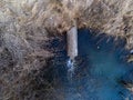 Aerial drone view, concrete pipe transporting the polluted sewage water Royalty Free Stock Photo