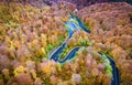 Aerial drone view of a curved winding road through the forest hi Royalty Free Stock Photo