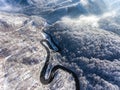 Aerial drone view of a curved winding road through the forest hi