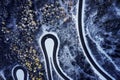 Aerial drone view of a curved winding road through the forest high up in the mountains in the winter with snow covered Royalty Free Stock Photo