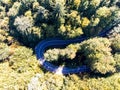 Aerial drone view, curving asphalt road , deciduous woods