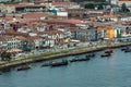 Aerial drone view of the Douro River and the Porto promenade with the old houses, rabelas, classic boats for the tourist routes of Royalty Free Stock Photo