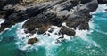Aerial Drone View Of Dramatic Ocean Crushing On Rocky Landscape