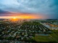 Aerial drone view dramatic sunset with fog and clouds above suburb in Central Texas