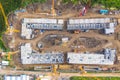 Aerial drone view of excavator loading the tipper truck at the construction site Royalty Free Stock Photo