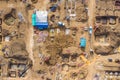 Aerial drone view of excavator loading the tipper truck at the construction site Royalty Free Stock Photo