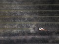 Aerial drone view of excavator making trenches for cultivated plantation