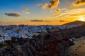 Aerial drone view of famous Oia village with white houses and blue dome churches during sunrise on Santorini island, Aegean sea, Royalty Free Stock Photo